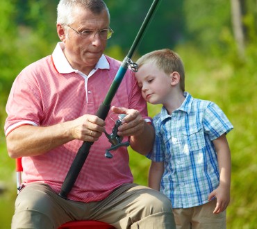 Vissen met opa en kleinkind op de camping met visvijver
